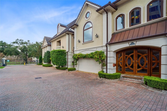 view of front facade with a garage and french doors