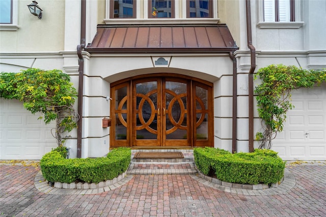 property entrance featuring french doors and a garage