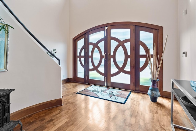 foyer entrance with light hardwood / wood-style flooring and french doors