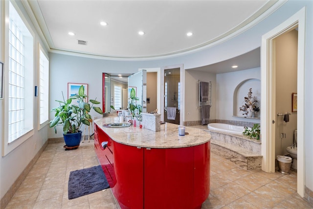 kitchen featuring crown molding, a center island, sink, and a wealth of natural light