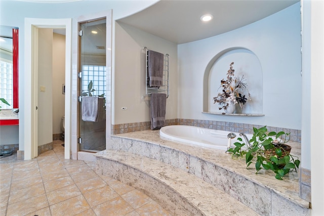 bathroom featuring separate shower and tub and tile patterned flooring