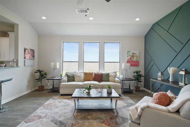 living room with hardwood / wood-style flooring, vaulted ceiling, and ceiling fan