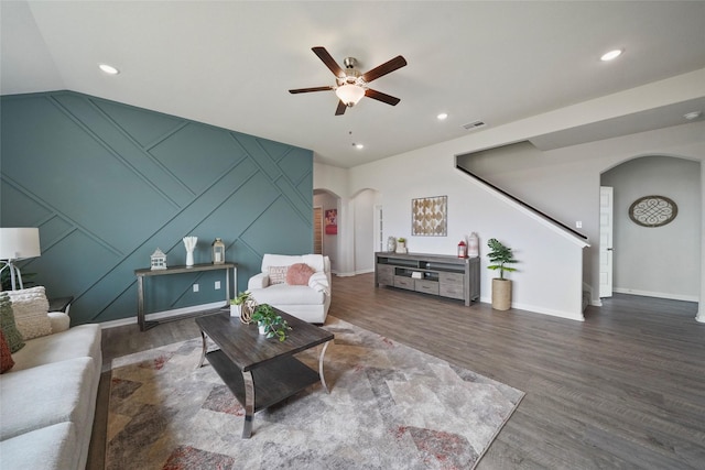 living room featuring dark hardwood / wood-style floors and ceiling fan