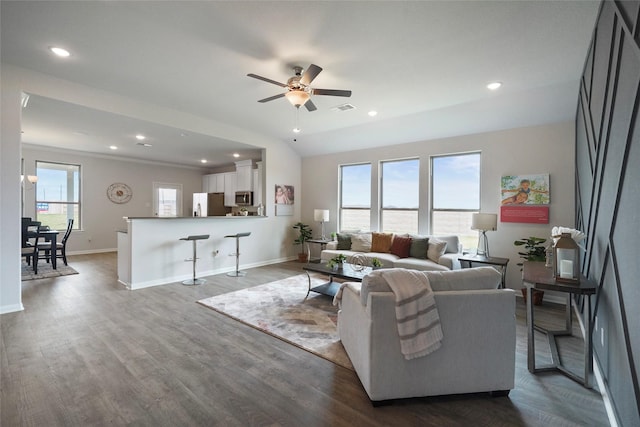 living room featuring ceiling fan and dark hardwood / wood-style flooring