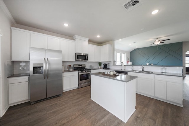 kitchen featuring appliances with stainless steel finishes, sink, and white cabinets