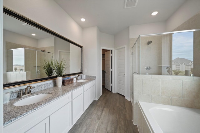 bathroom with vanity, hardwood / wood-style floors, and independent shower and bath