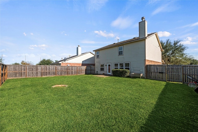 rear view of house with a lawn