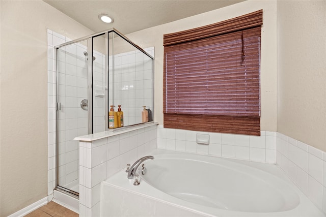 bathroom with tile patterned flooring and plus walk in shower