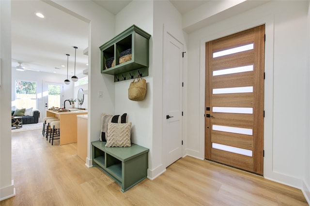 mudroom featuring ceiling fan and light wood-type flooring