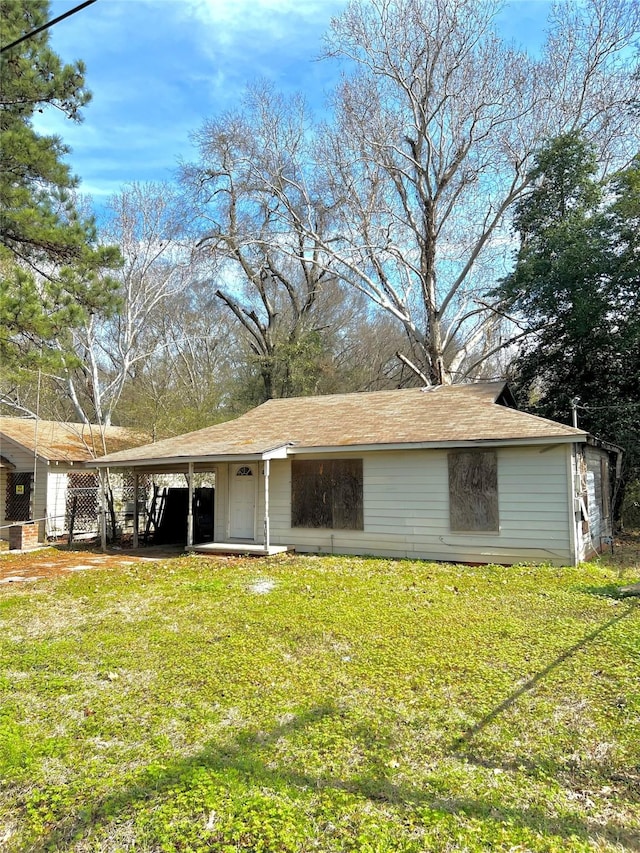 rear view of property with a yard