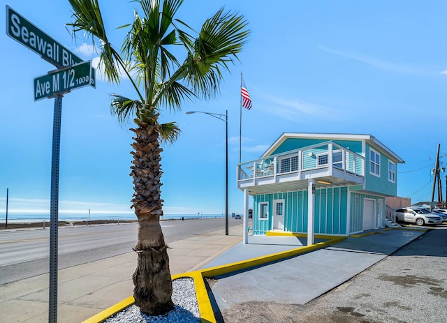 view of front of property featuring a garage and a water view