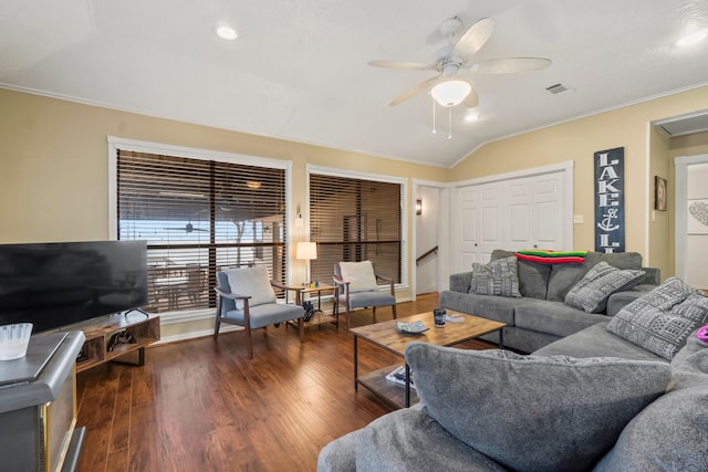 living room featuring dark hardwood / wood-style flooring, vaulted ceiling, ornamental molding, and ceiling fan