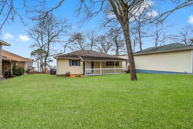 back of house with a porch and a lawn