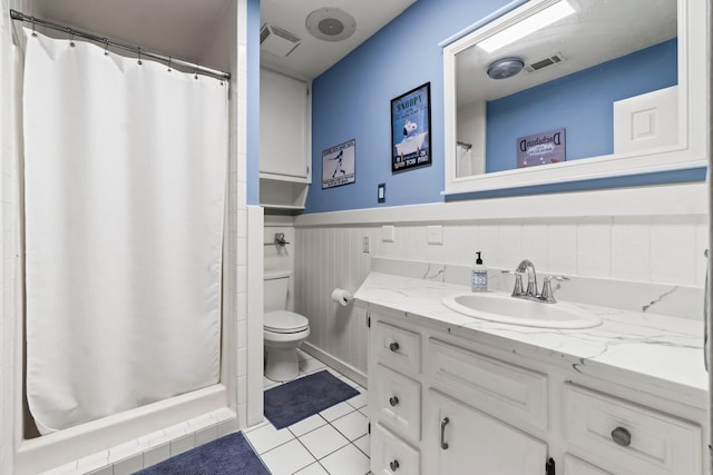 bathroom with vanity, a shower with curtain, tile patterned floors, and toilet