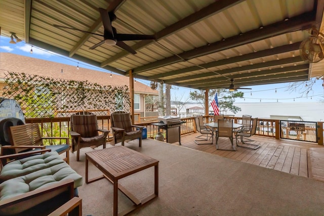 wooden deck with an outdoor hangout area and ceiling fan