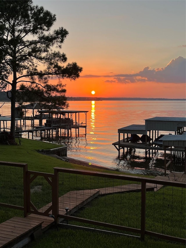 view of dock featuring a yard and a water view