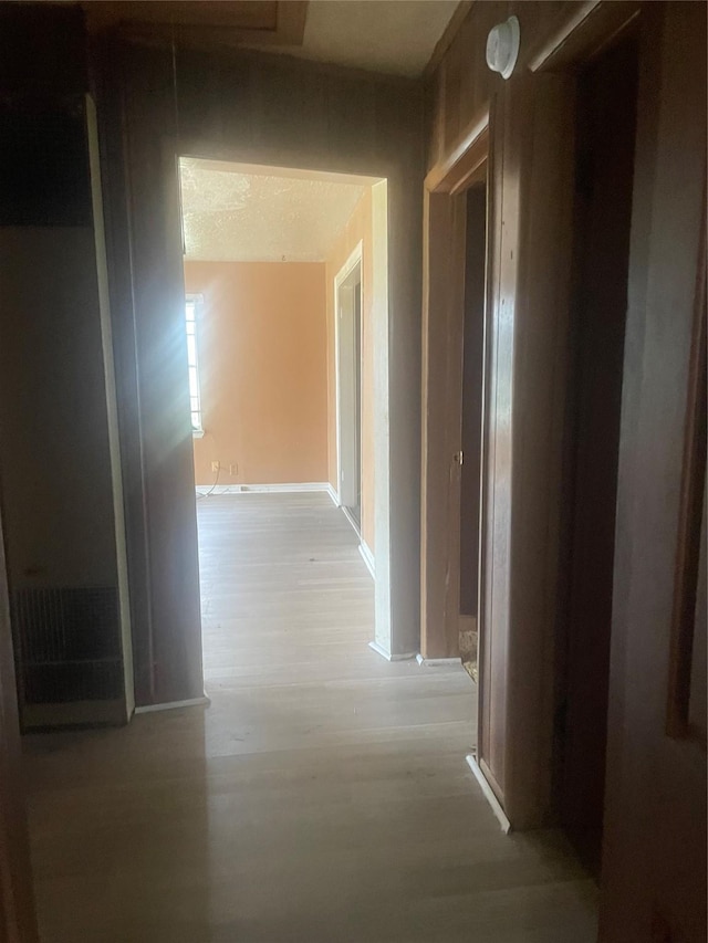 hallway with light hardwood / wood-style flooring