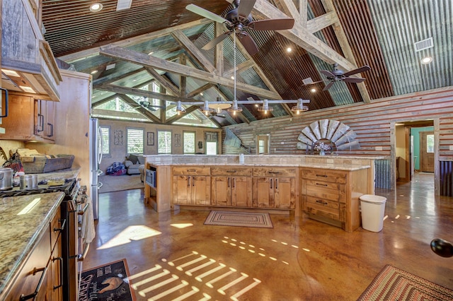 kitchen with ceiling fan, appliances with stainless steel finishes, and high vaulted ceiling