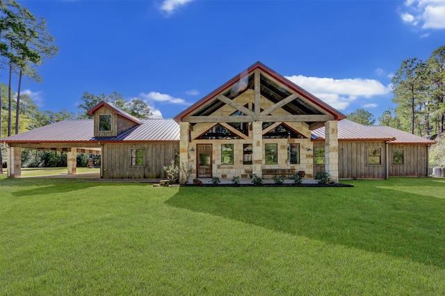 rear view of house featuring a yard