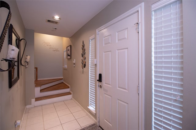 corridor with light tile patterned floors