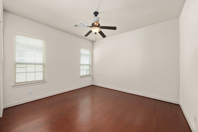 unfurnished room with dark hardwood / wood-style floors and ceiling fan