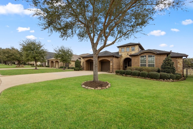 mediterranean / spanish house featuring a front lawn