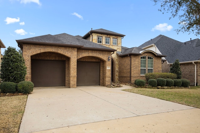 view of front of house with a garage and a front yard