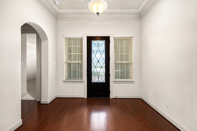 foyer with ornamental molding and dark hardwood / wood-style flooring