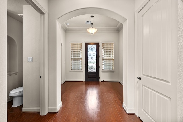 entryway featuring crown molding and dark hardwood / wood-style floors