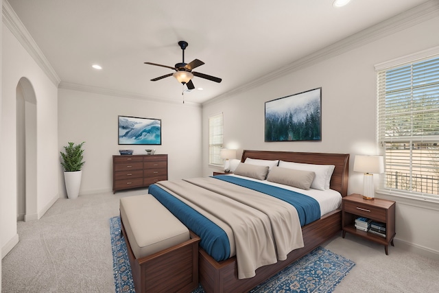 carpeted bedroom with crown molding and ceiling fan