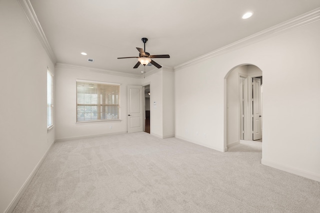 carpeted empty room featuring ornamental molding and ceiling fan