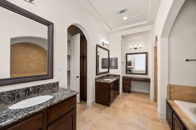 bathroom featuring vanity and a washtub