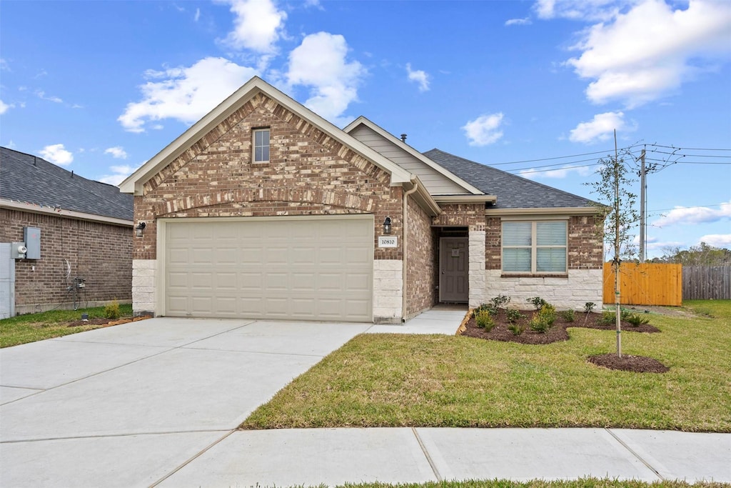 view of front of house featuring a garage and a front yard