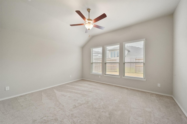 carpeted empty room with vaulted ceiling and ceiling fan