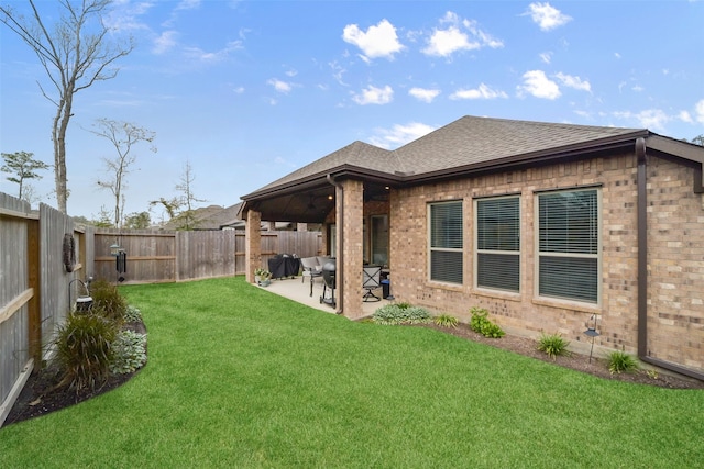 rear view of house featuring a lawn and a patio