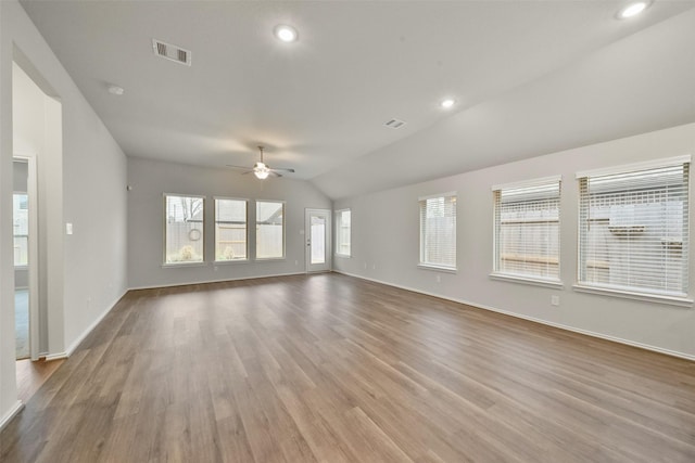 unfurnished living room featuring vaulted ceiling, light hardwood / wood-style floors, and ceiling fan