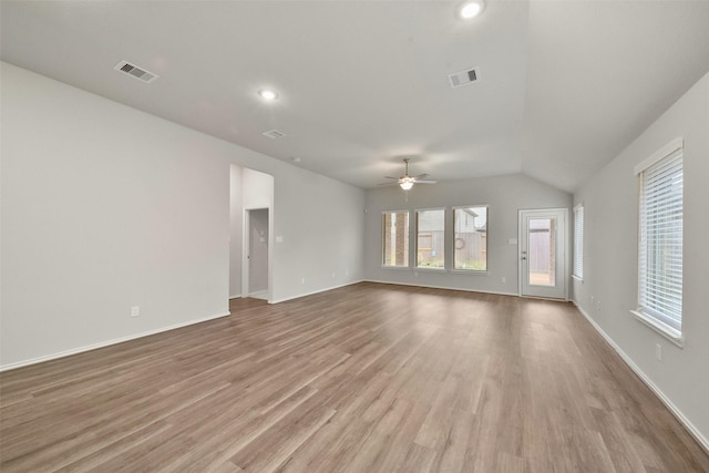 empty room featuring lofted ceiling, ceiling fan, and light hardwood / wood-style flooring