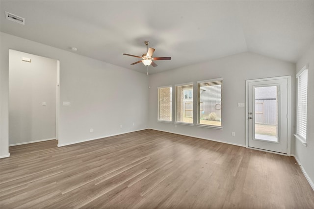 unfurnished living room with vaulted ceiling, ceiling fan, and light wood-type flooring