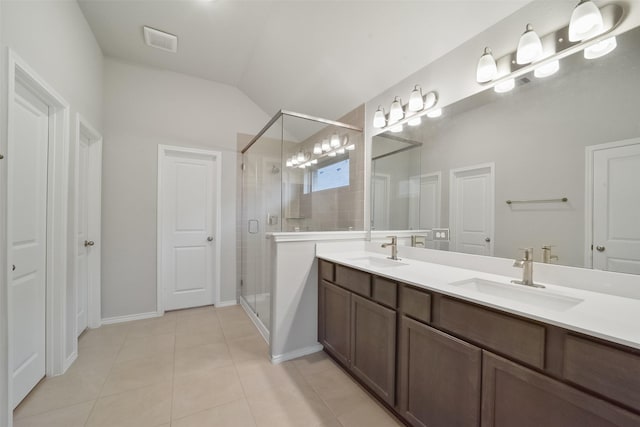 bathroom with tile patterned flooring, vaulted ceiling, vanity, and a shower with shower door