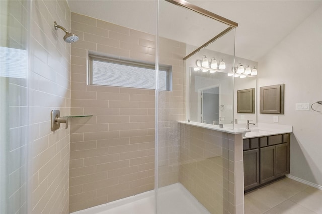 bathroom featuring vanity, tile patterned flooring, and tiled shower