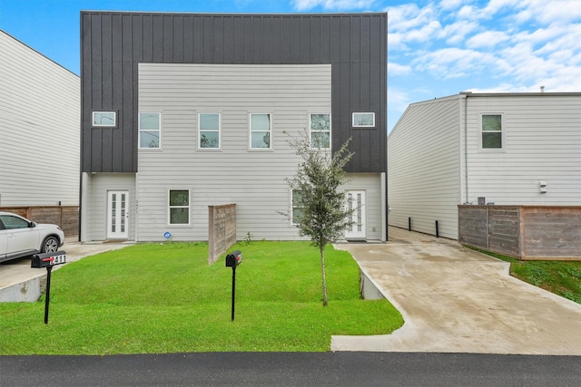 view of front facade featuring a front lawn and french doors