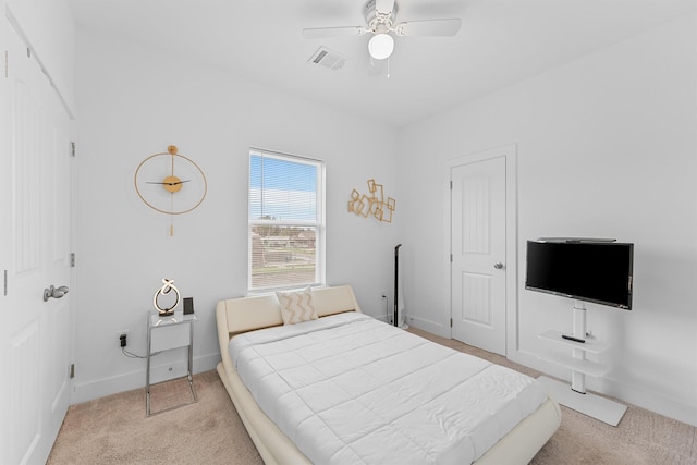 bedroom with light colored carpet and ceiling fan