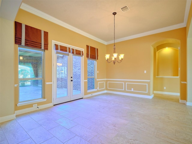 spare room featuring crown molding, an inviting chandelier, and french doors