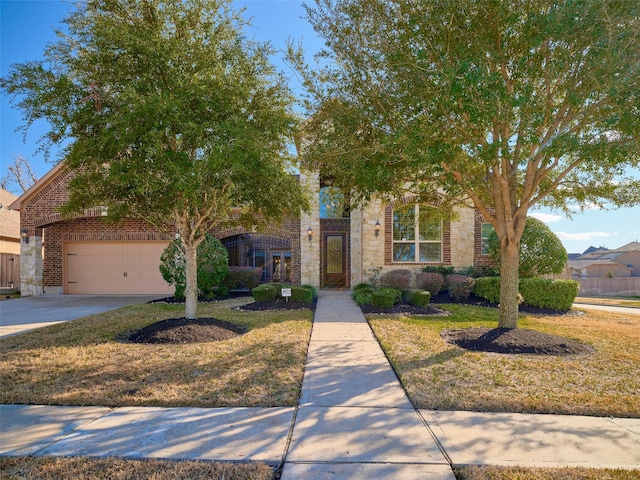 view of property hidden behind natural elements with a garage and a front yard