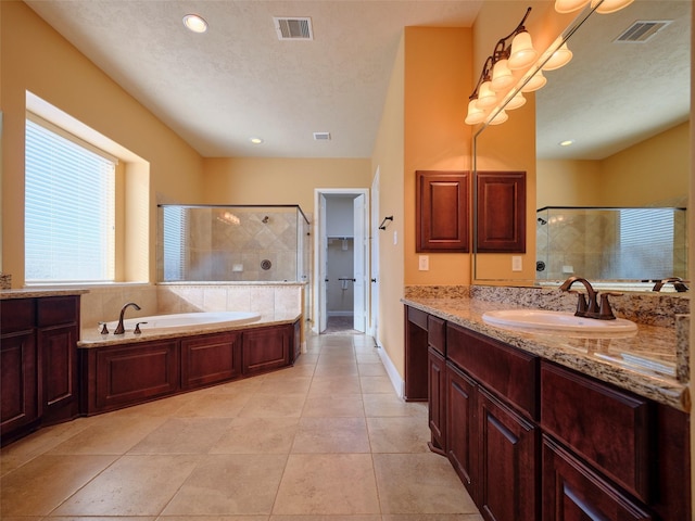 bathroom featuring tile patterned flooring, vanity, and shower with separate bathtub