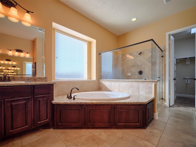 bathroom featuring plus walk in shower, tile patterned floors, and vanity