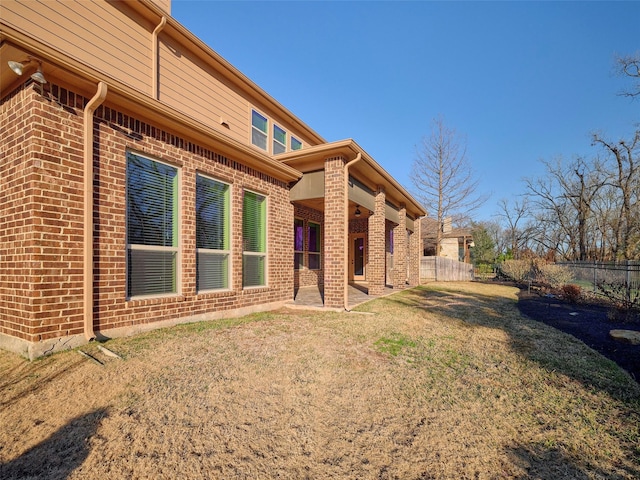 rear view of property with a lawn