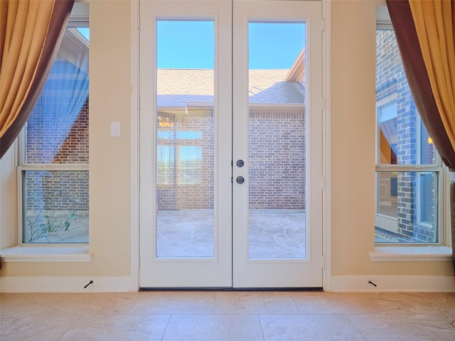 doorway featuring light tile patterned flooring and french doors