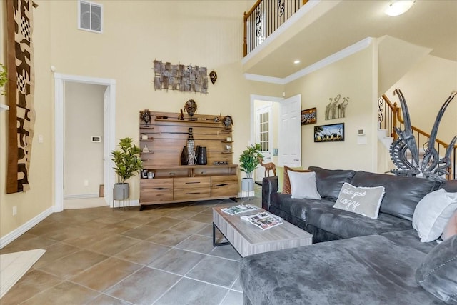 living room with tile patterned floors and a high ceiling