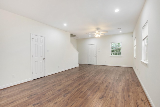 spare room with ceiling fan and dark hardwood / wood-style flooring